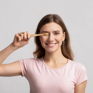 Eco Living Concept. Happy Beautiful Young Woman Holding Natural Wooden Bamboo Toothbrush