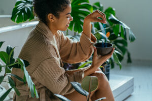 Young Woman Enjoying Morning Routine In Bathrrom. Eco Friendly Cleaning Kit. Organic Soap And Jute Washcloth In The Woman's Hand. Zero Waste Concept, Plastic Free, Eco Friendly Shopping, Vegan