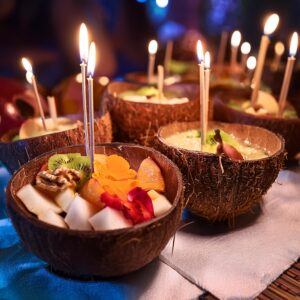 Firefly Coconut Bowls Filled With Food And Candles At A Party 1179