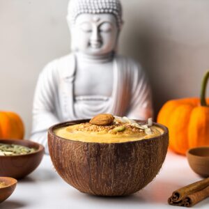 Firefly Pumpkin Spice Smoothie Bowl In A Smooth Coconut Bowl, Blurred Background On A White Counter (1)